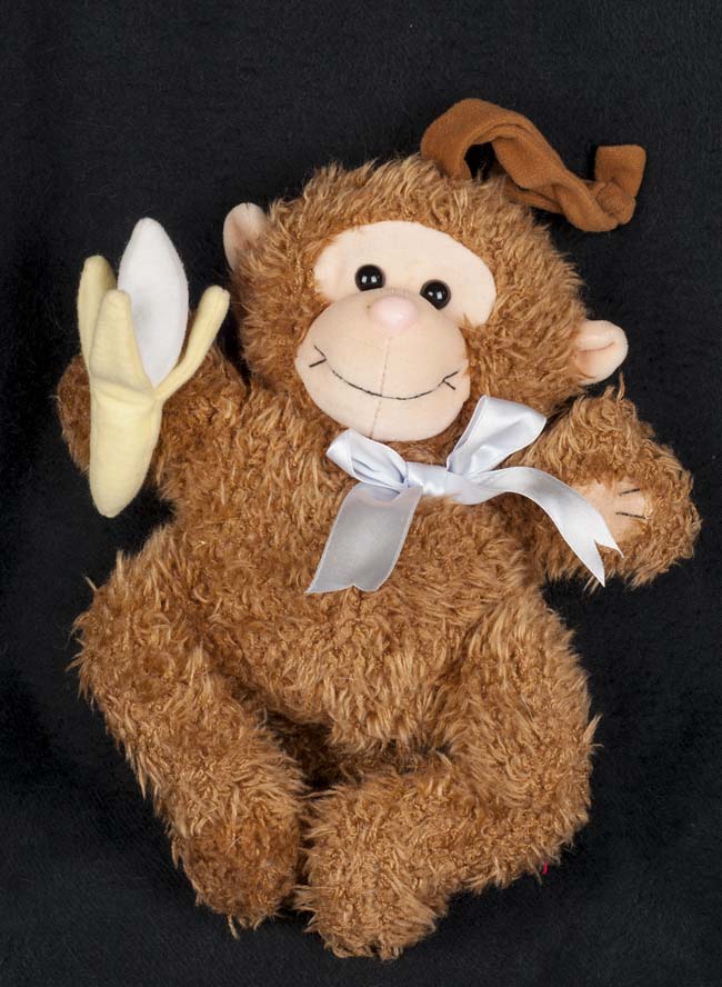 vintage stuffed monkey holding banana